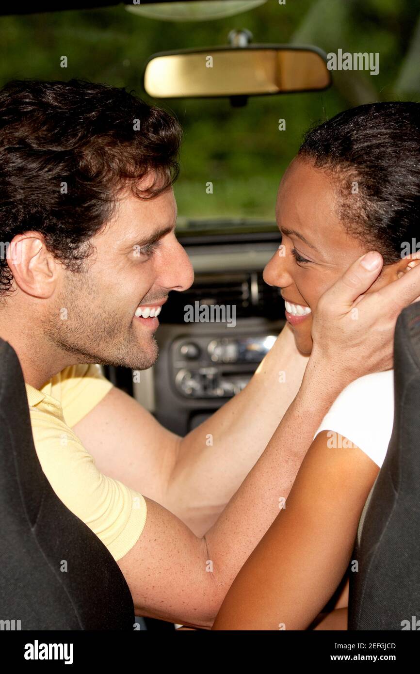 Side profile of a young woman embracing a mid adult man Stock Photo - Alamy