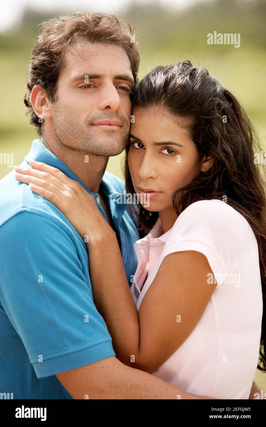 Mid adult man embracing a young woman Stock Photo - Alamy