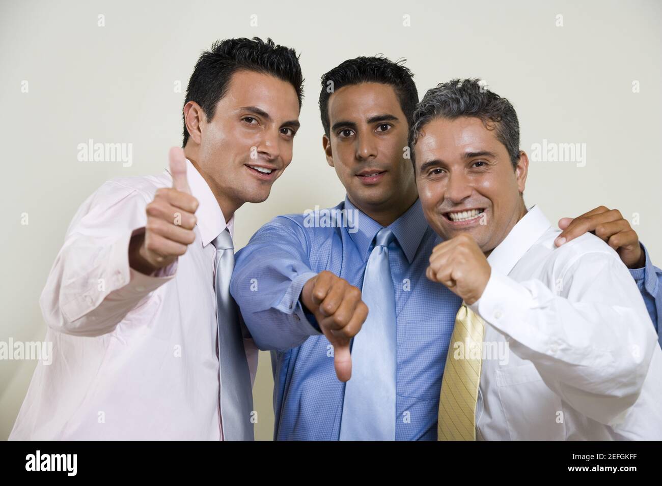 Portrait of three businessmen gesturing thumbs up Stock Photo - Alamy