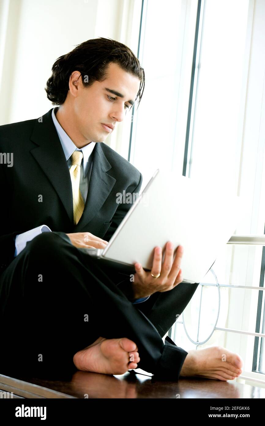Businessman sitting and using a laptop Stock Photo