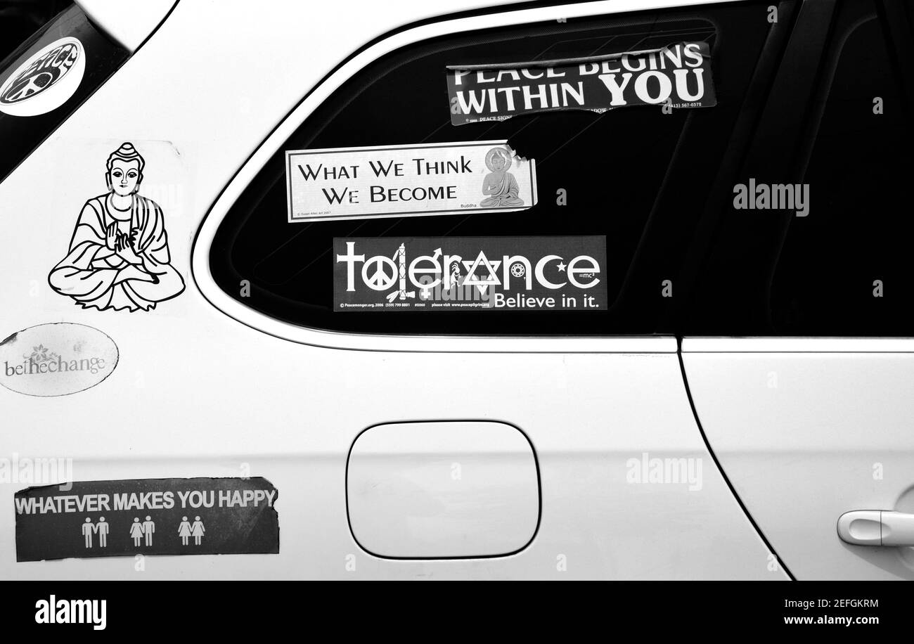 Bumper stickers and decals on a car reflect the owner's Buddhist faith and liberal points of view. Stock Photo