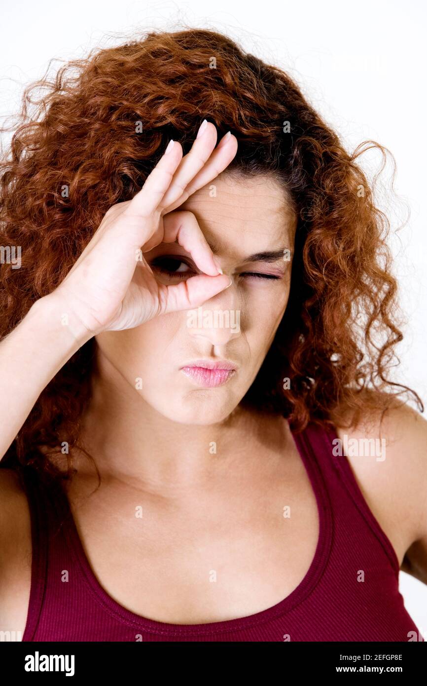 Portrait of a young woman winking Stock Photo - Alamy