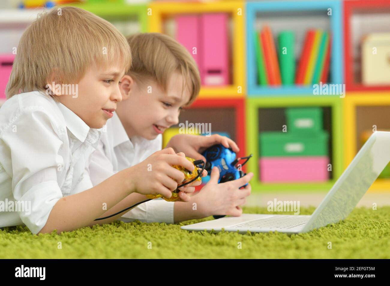 Portrait of two boys playing computer games Stock Photo - Alamy