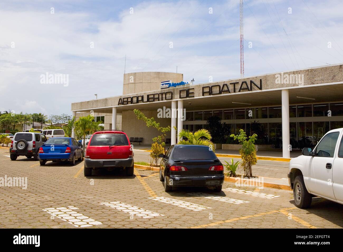 Cars parked in front of an airport entrance, Roatan, Bay Islands