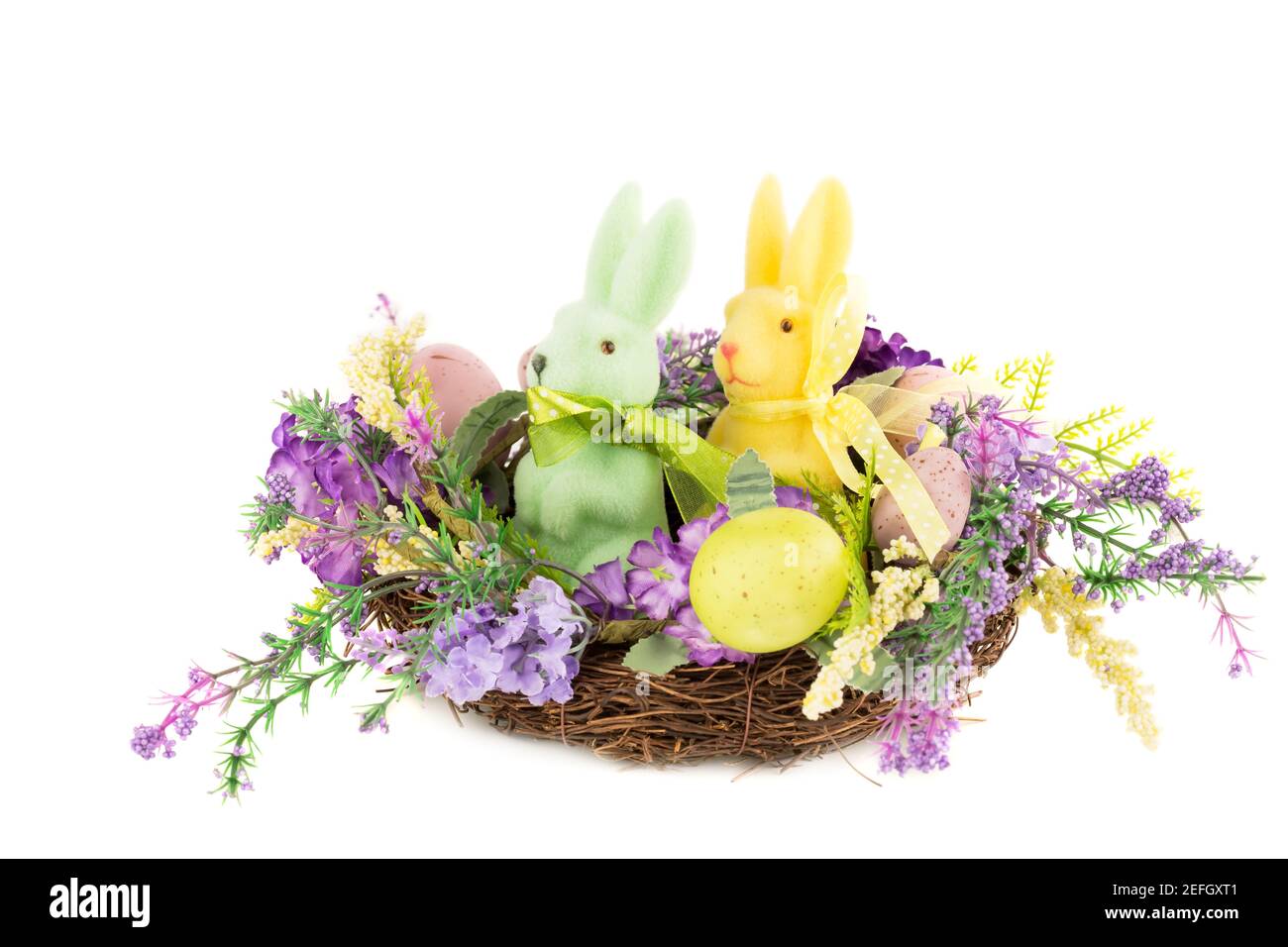 Easter colorful eggs and bunnies in nest, flowers isolated on white ...
