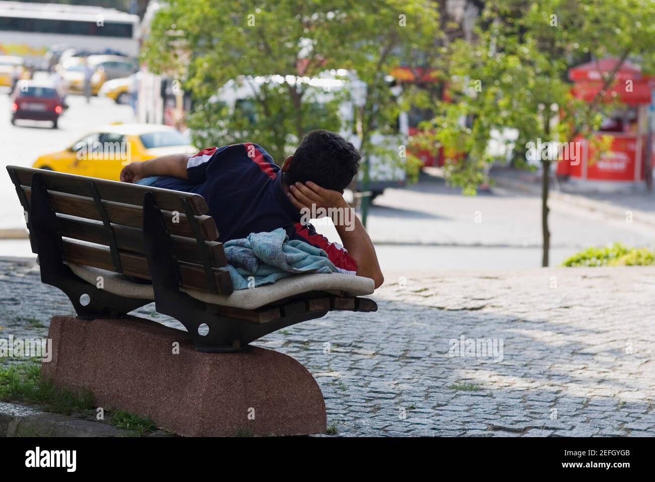 Rear view of a man lying on a park bench, Istanbul, Turkey Stock Photo ...