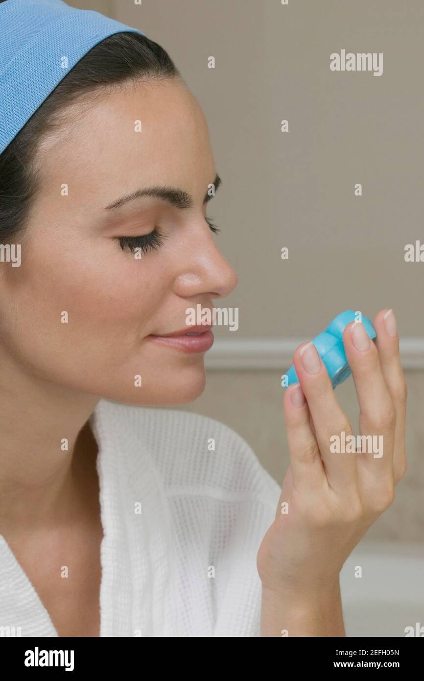 Closeup of a young woman smelling a bar of soap Stock Photo Alamy