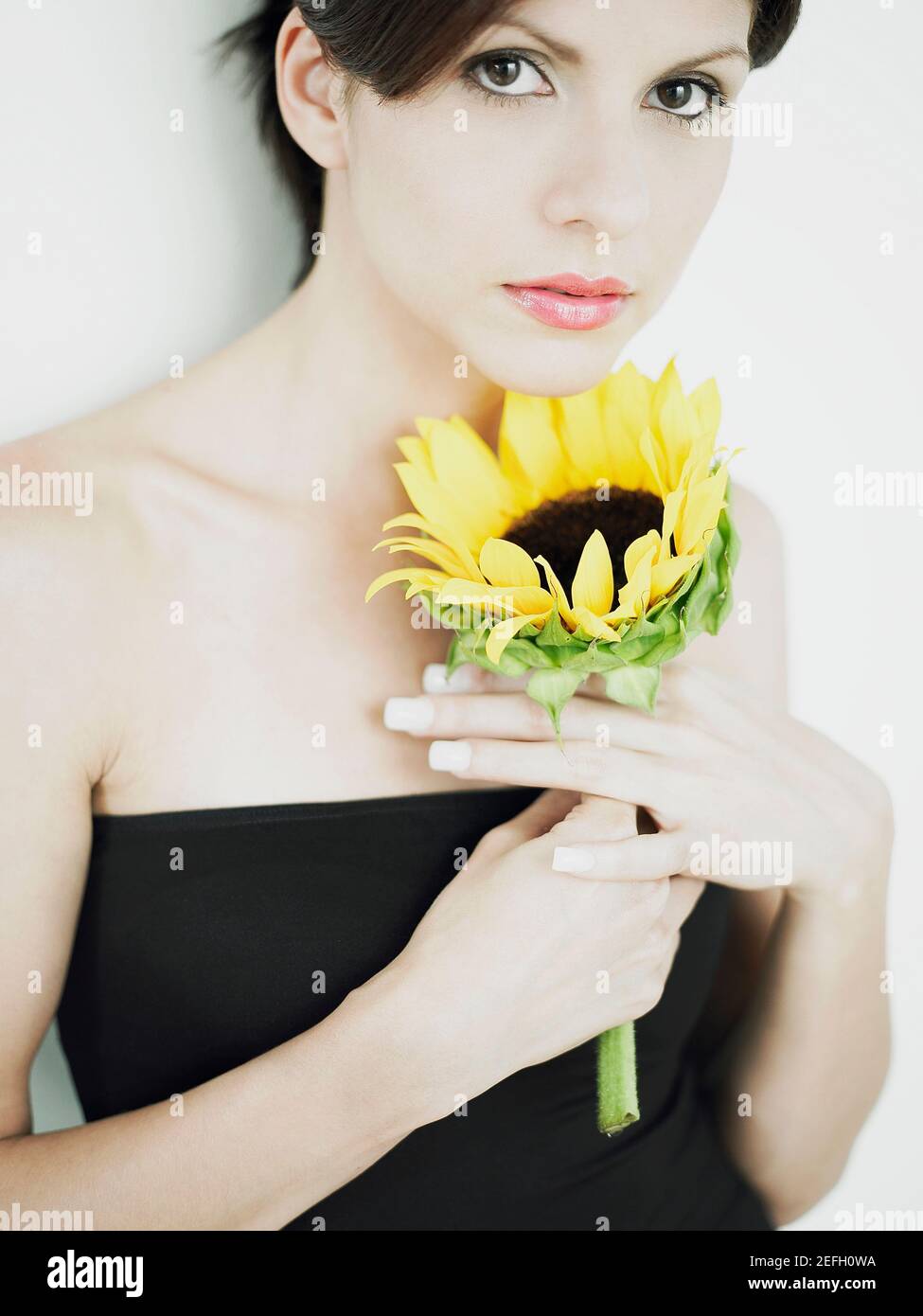 Woman holding a sunflower hi-res stock photography and images - Alamy