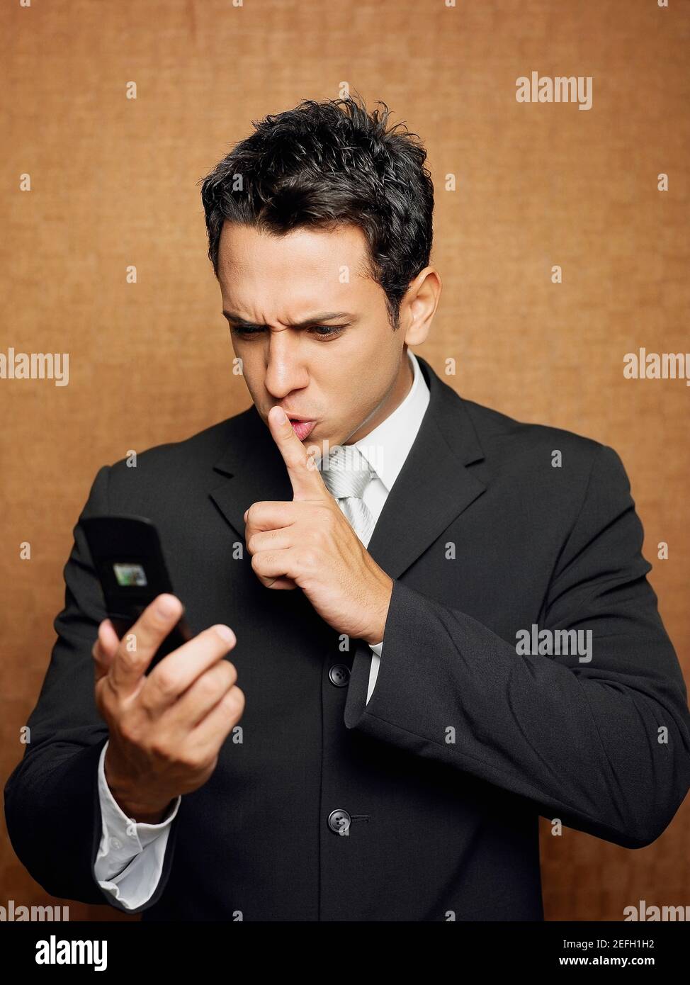 Close up of a businessman holding a mobile phone and gesturing Stock Photo