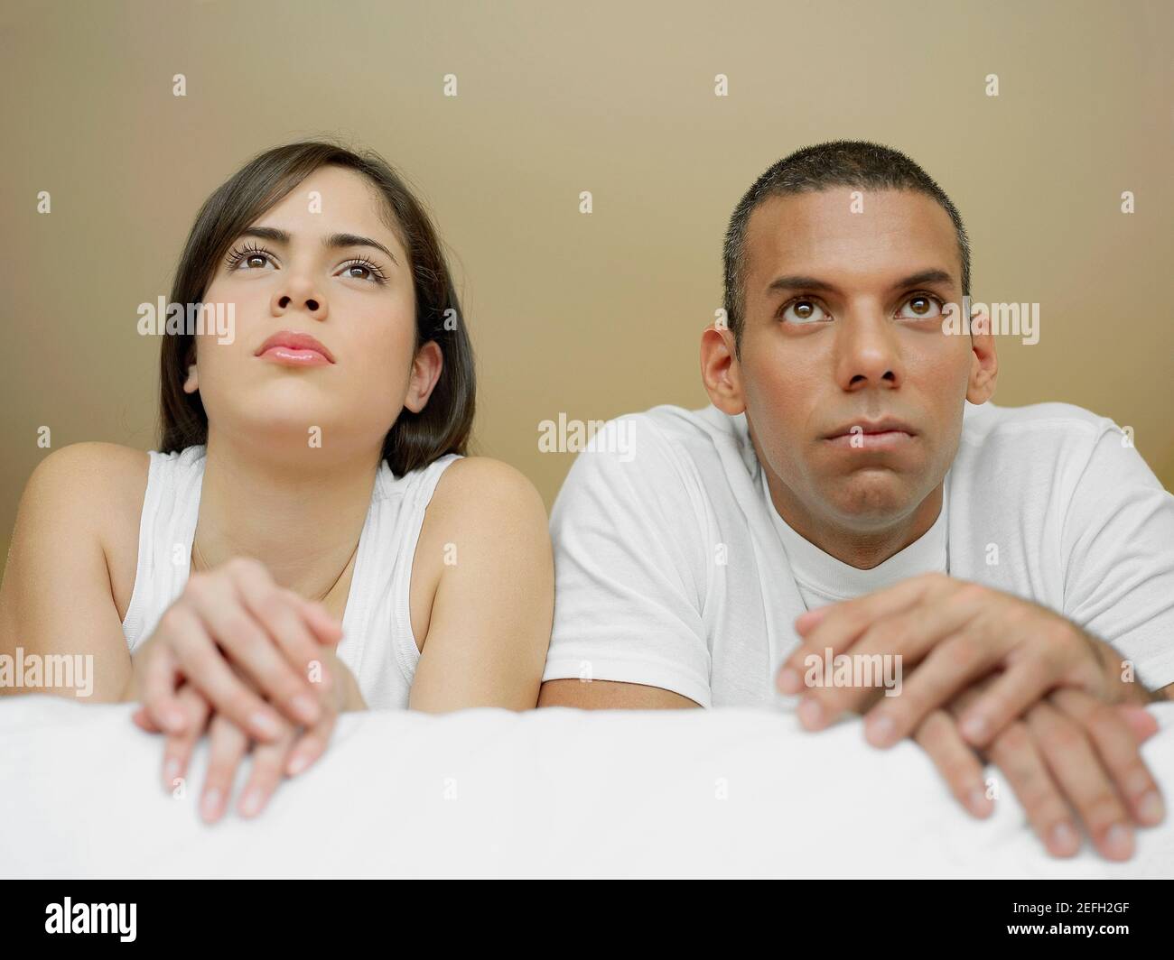 Close up of a mid adult man and a young woman lying on the bed Stock ...