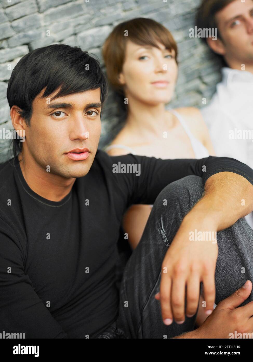 Portrait of two young men and a young woman Stock Photo - Alamy