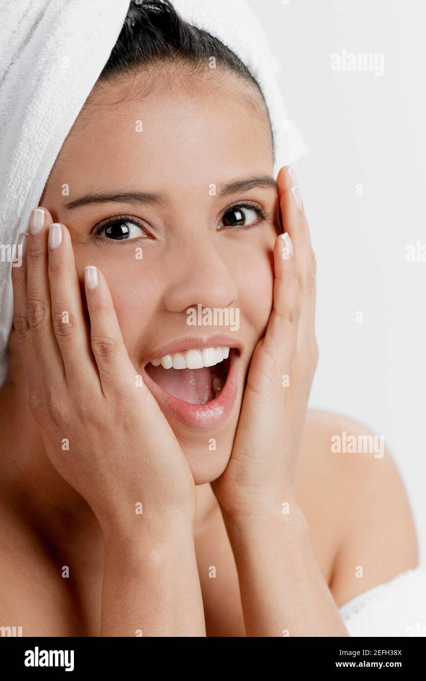 Portrait of a young woman with a towel wrapped around her head Stock ...