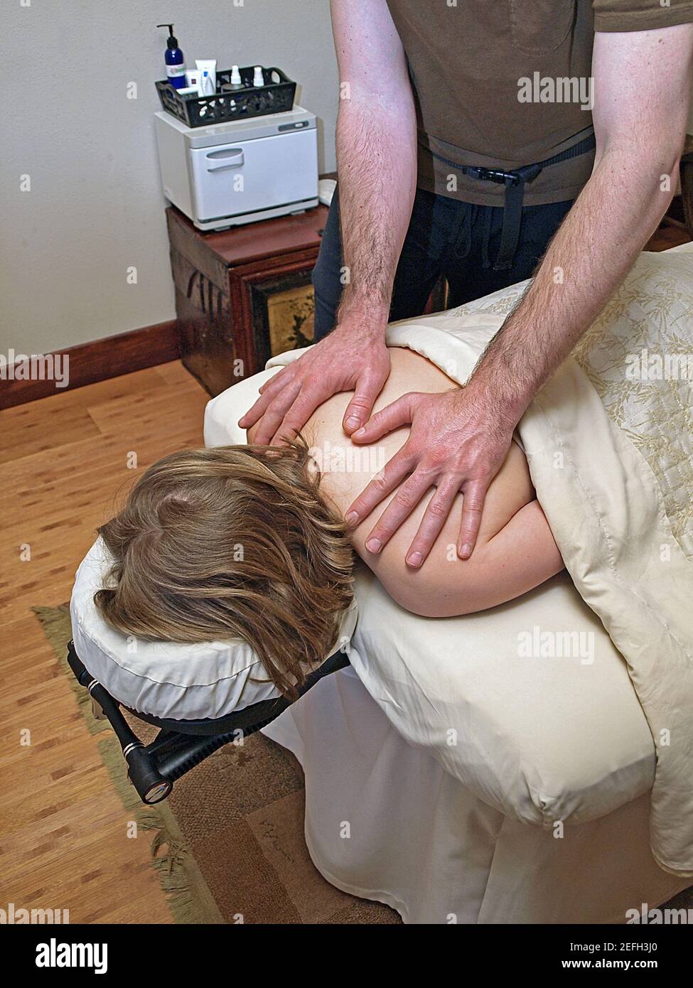 A masseur giving a woman a massage at an expensive spa. Stock Photo