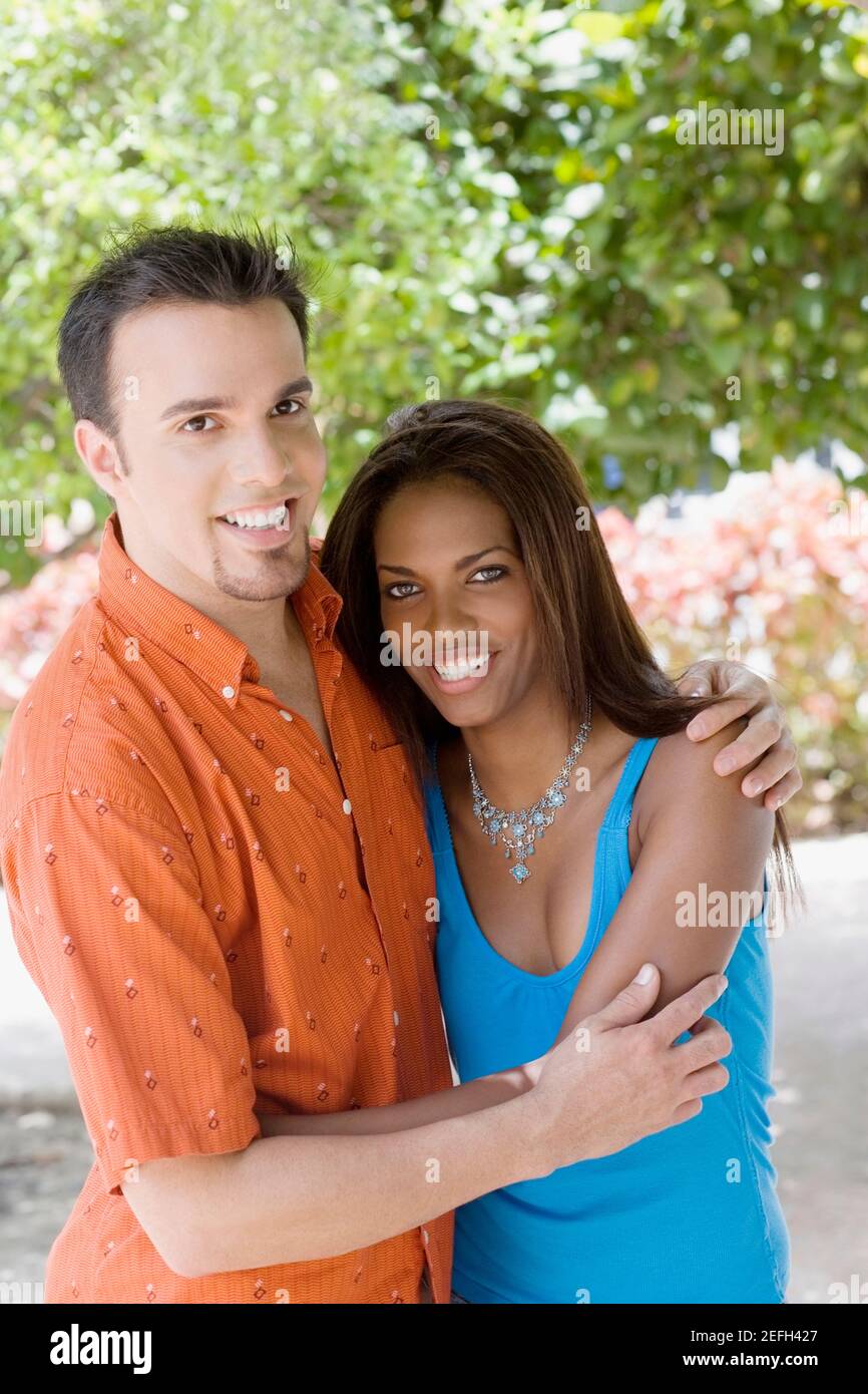 Portrait of a mid adult man and a teenage girl embracing each other ...