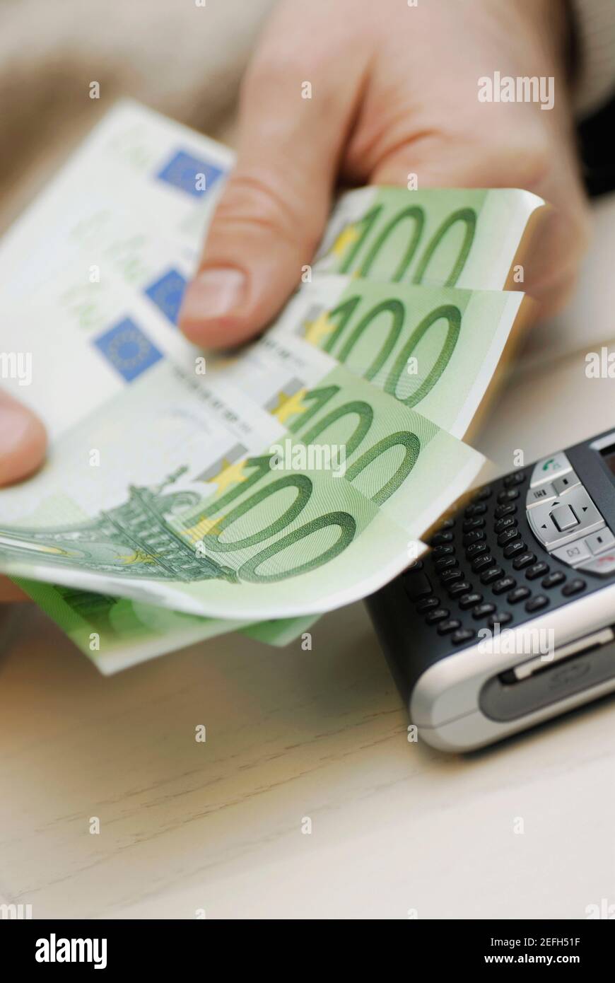 Close up of a personŽs hand counting one hundred Euro banknotes Stock Photo