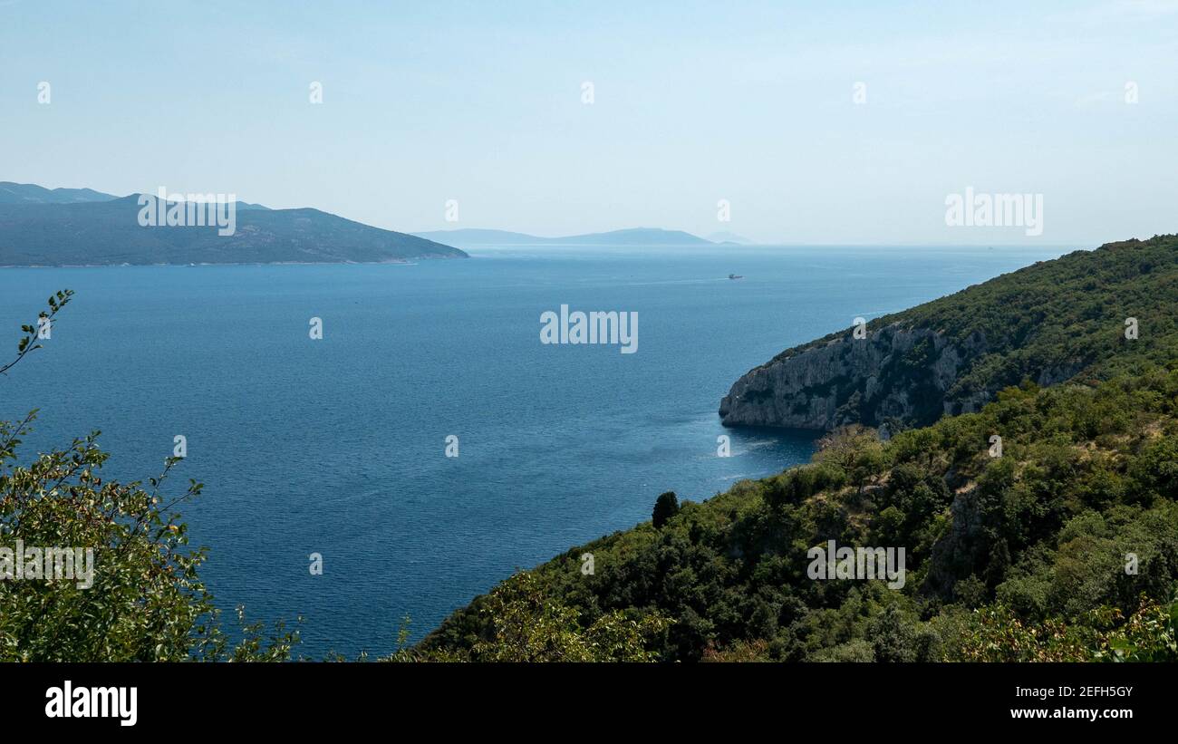 Landscape of the sea surrounded by cliffs covered in greenery under a ...