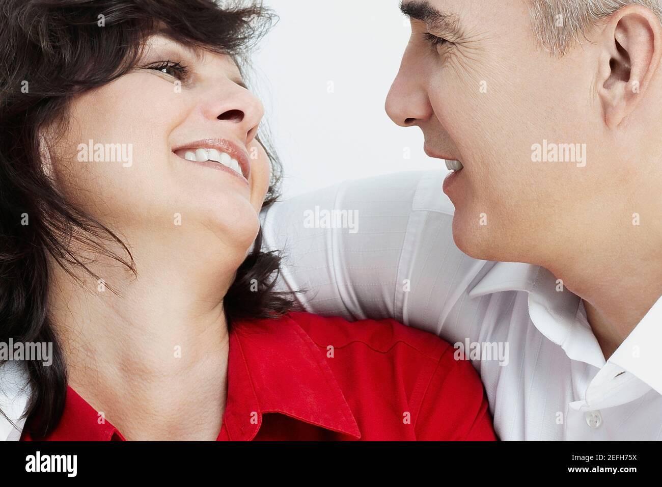 Close_up of a mature couple looking at each other smiling Stock Photo