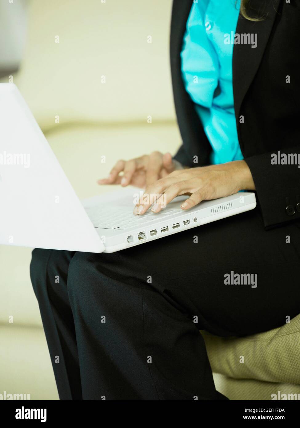 Mid section view of a businesswoman using a laptop Stock Photo