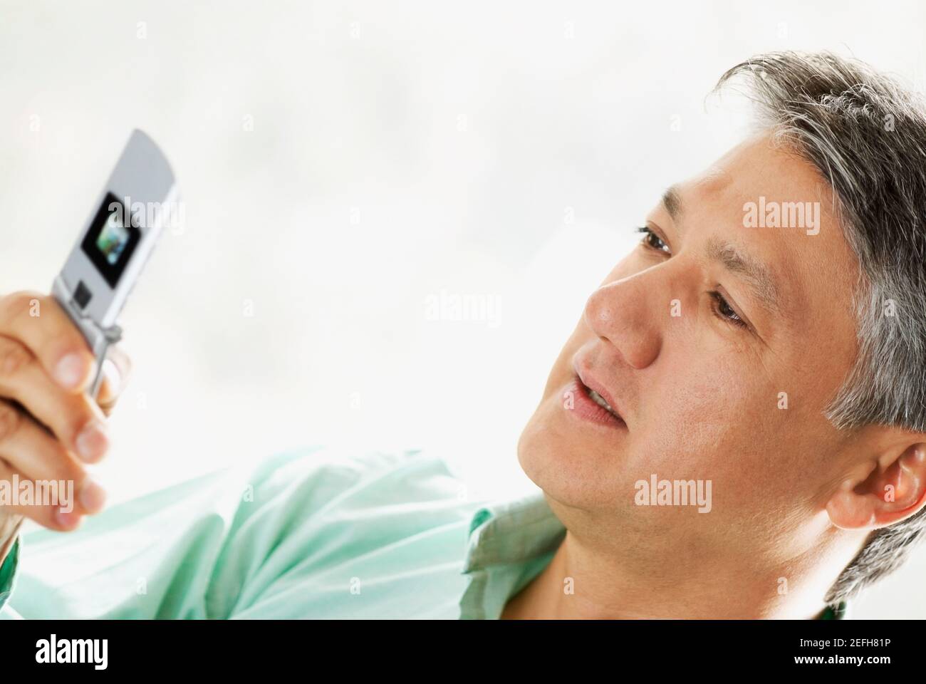 Close-up of a senior man looking at a mobile phone Stock Photo