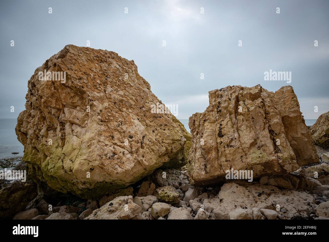 Huge chunks of chalk cliff face which have collapsed onto the beach near Cuckmere Haven, East Sussex, UK Stock Photo