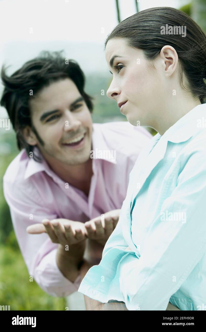 Mid adult man pleading to a young woman Stock Photo