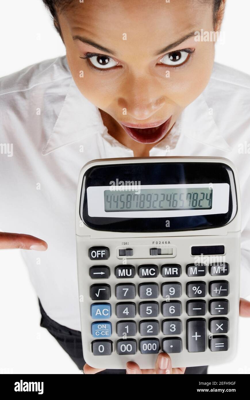 Portrait of a businesswoman holding a calculator with her mouth open Stock Photo