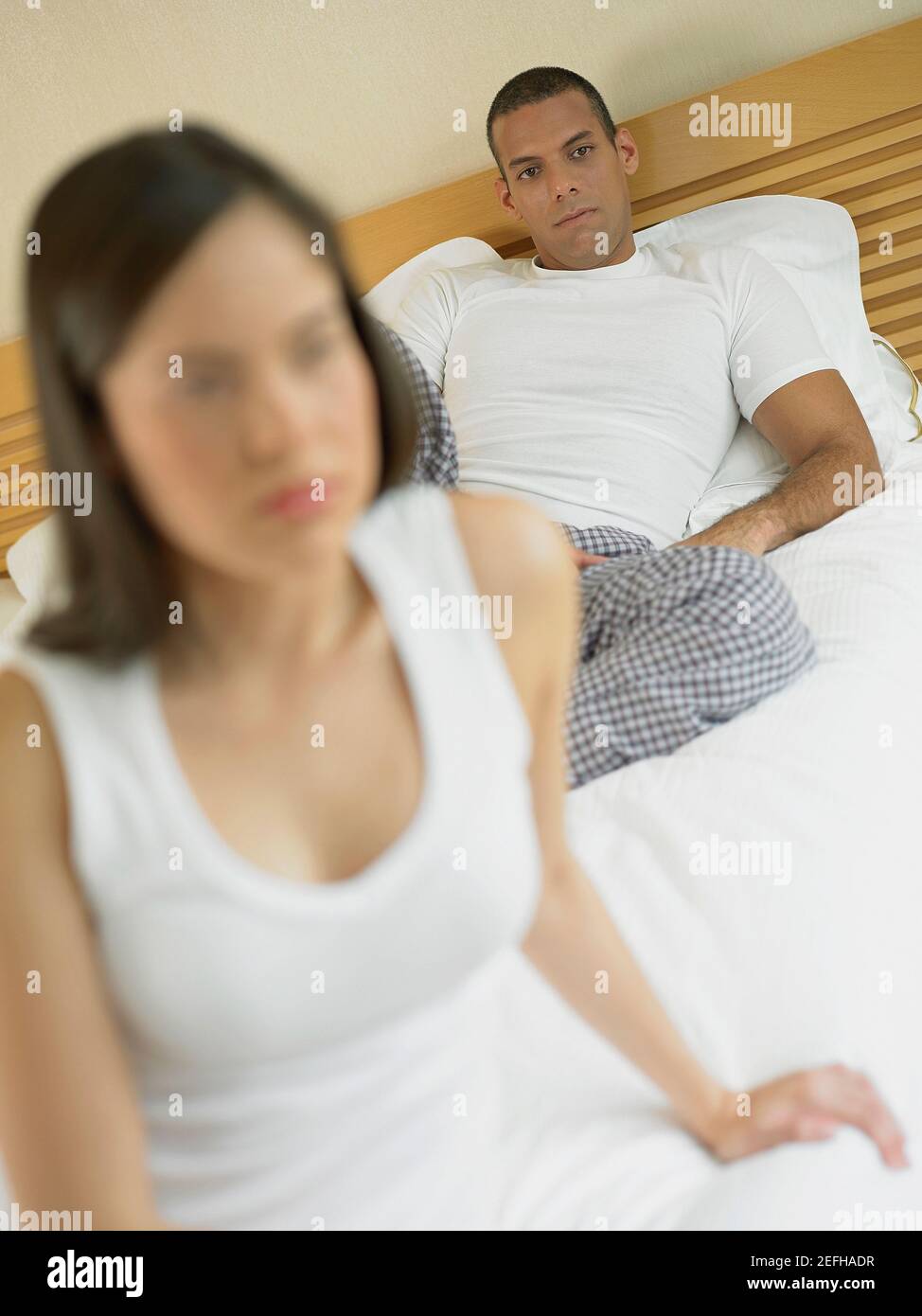 Close up of a young woman and a mid adult man lying on the bed Stock ...