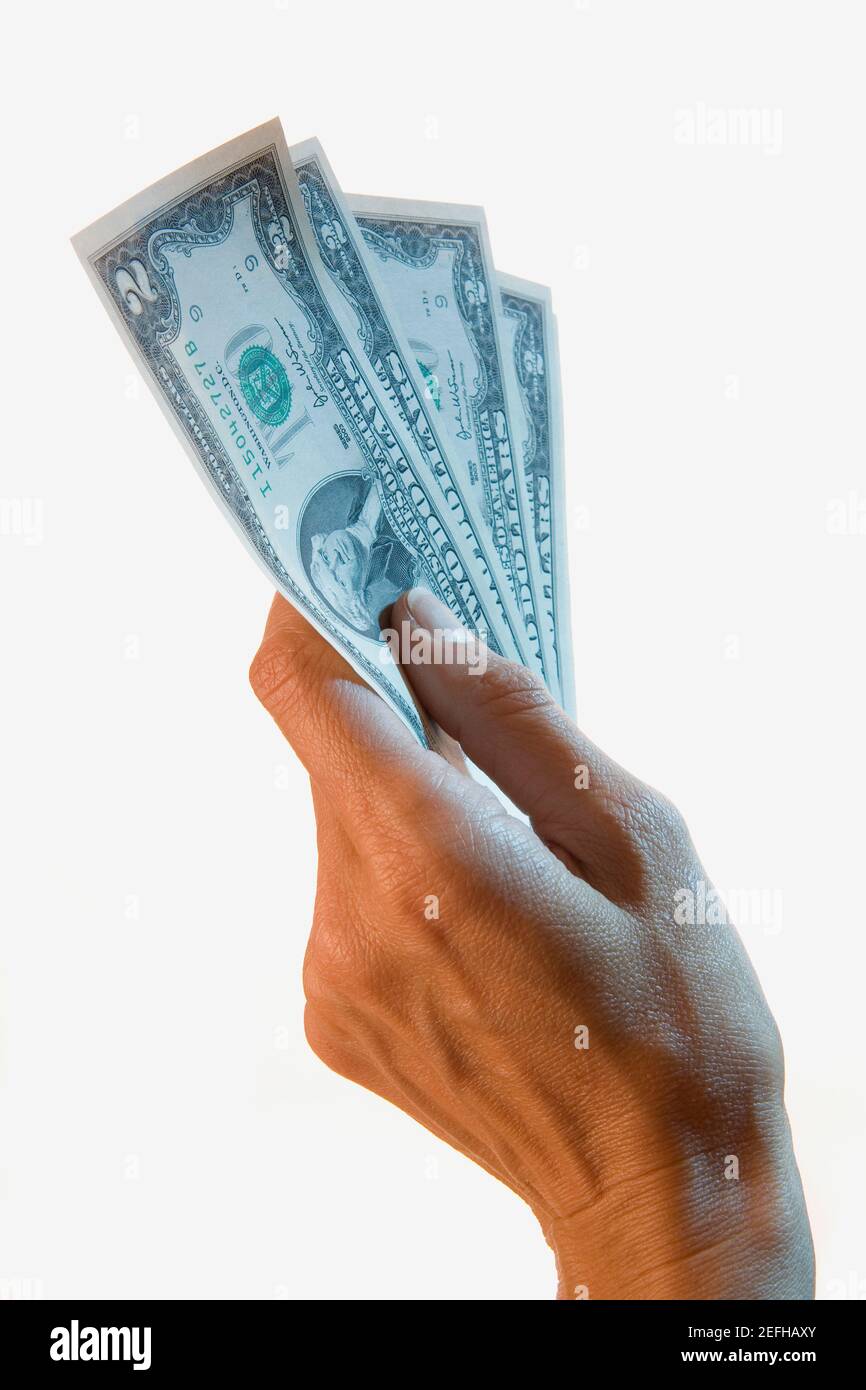Close up of a personŽs hand holding two dollar bills Stock Photo
