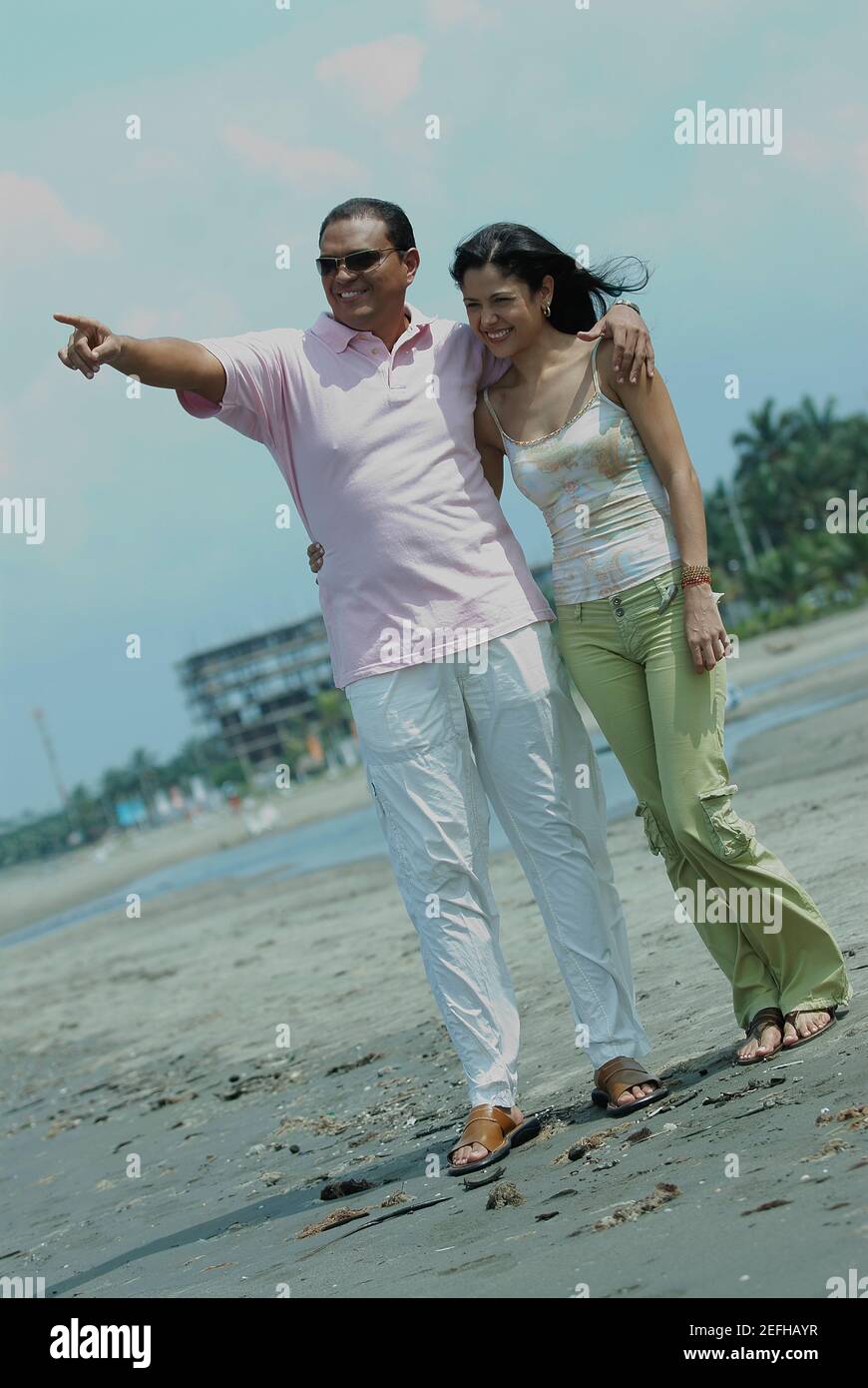 Mid adult man and a young woman standing and smiling Stock Photo - Alamy