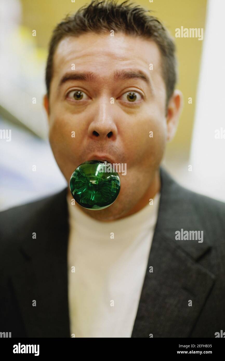 Portrait of a mid adult man with a light bulb in his mouth Stock Photo