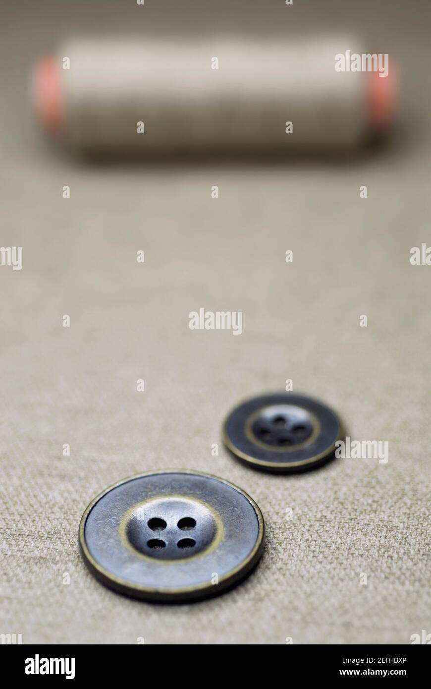Close up of buttons with a spool of thread Stock Photo - Alamy