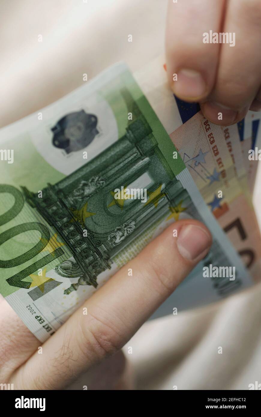 Close up of a personŽs hand counting Euro banknotes Stock Photo