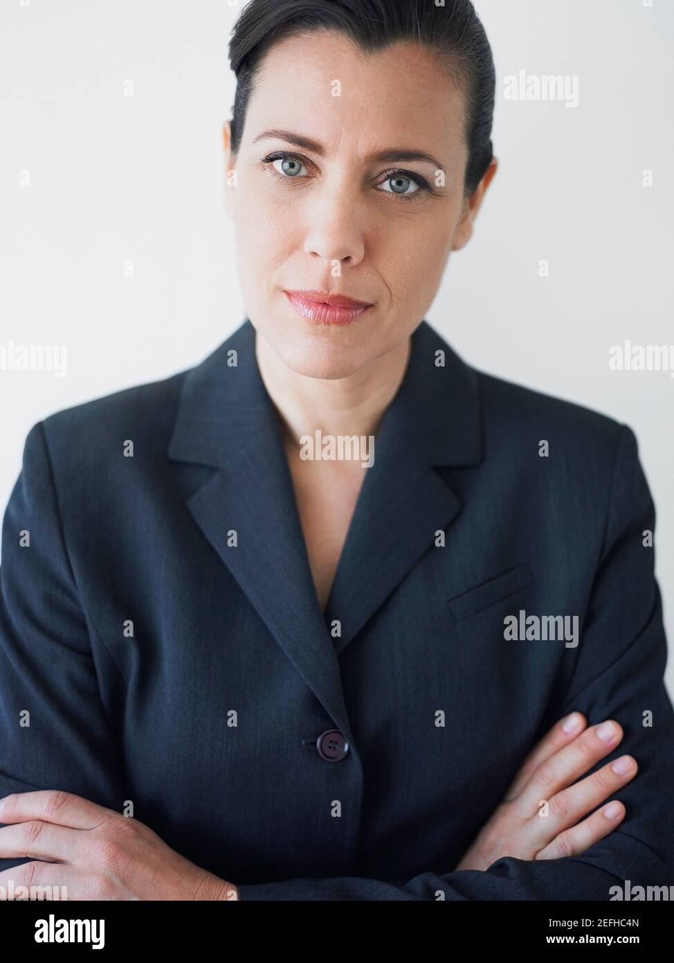 Portrait of a businesswoman smirking with her arms crossed Stock Photo