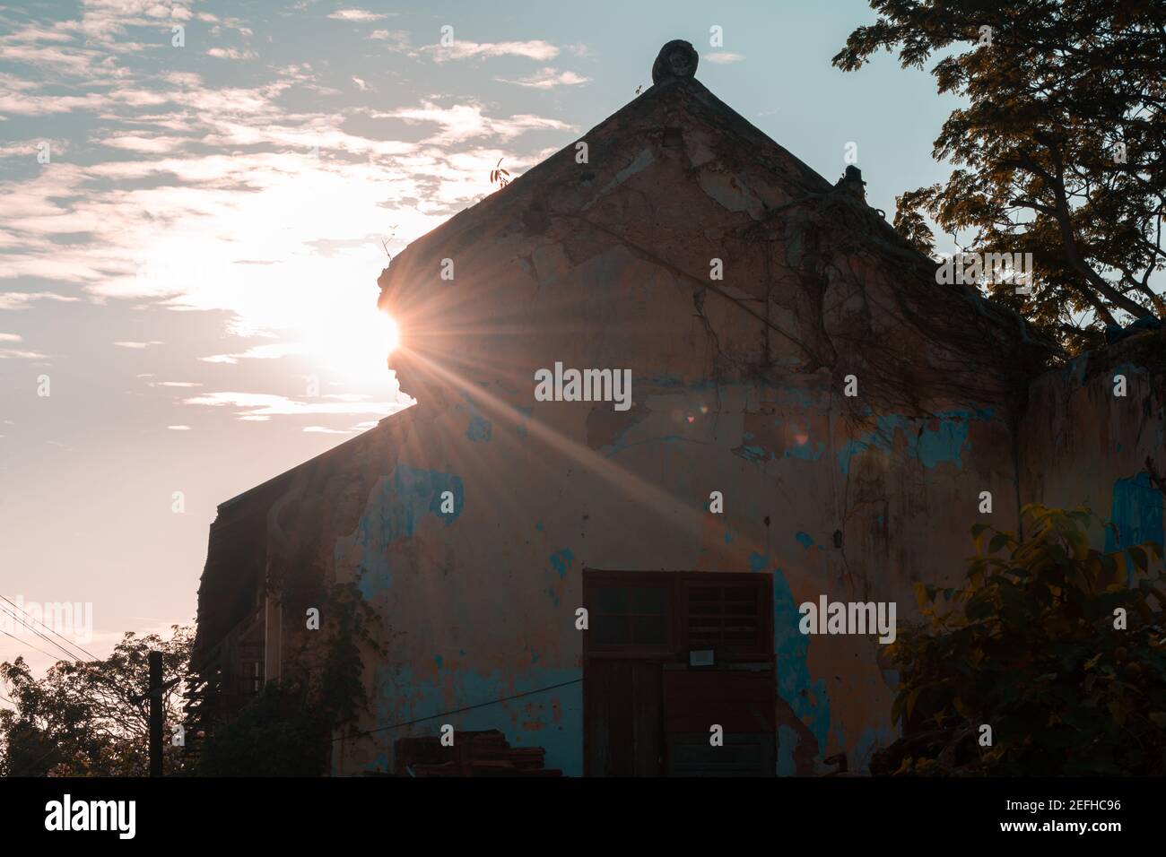 Sun peeking through Old abandoned building's roof, walls are cracked ...