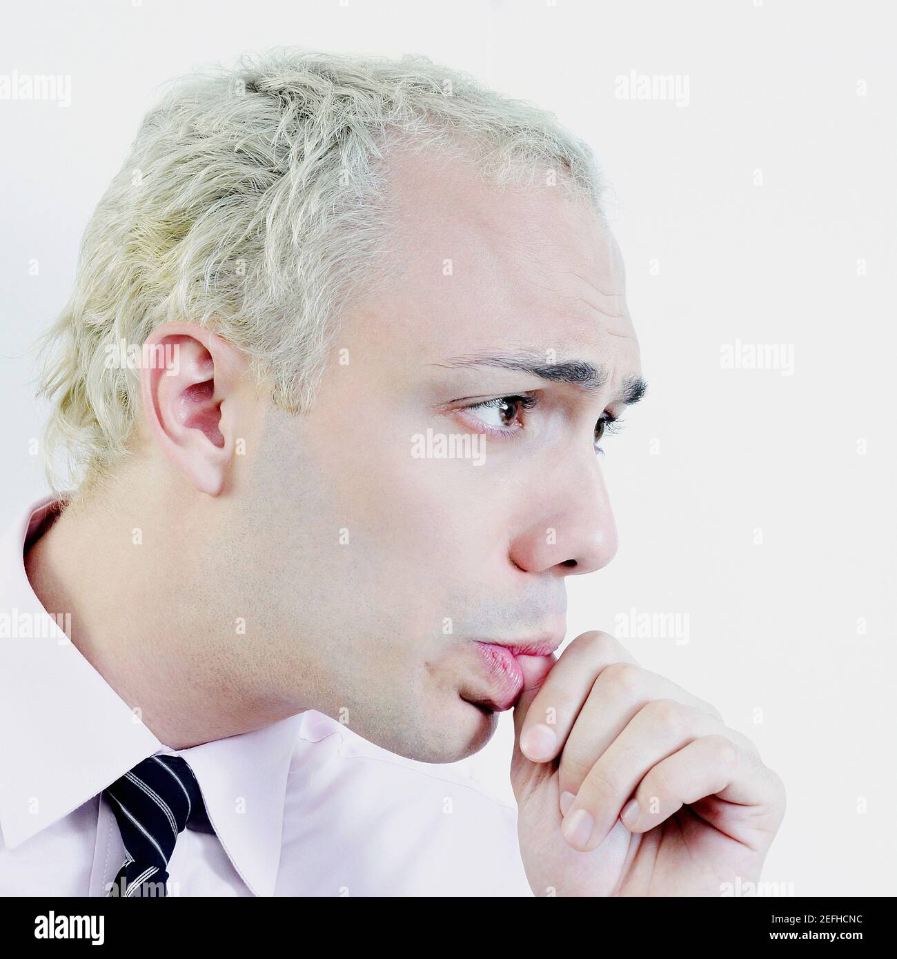 Close up of a businessman sucking his thumb Stock Photo