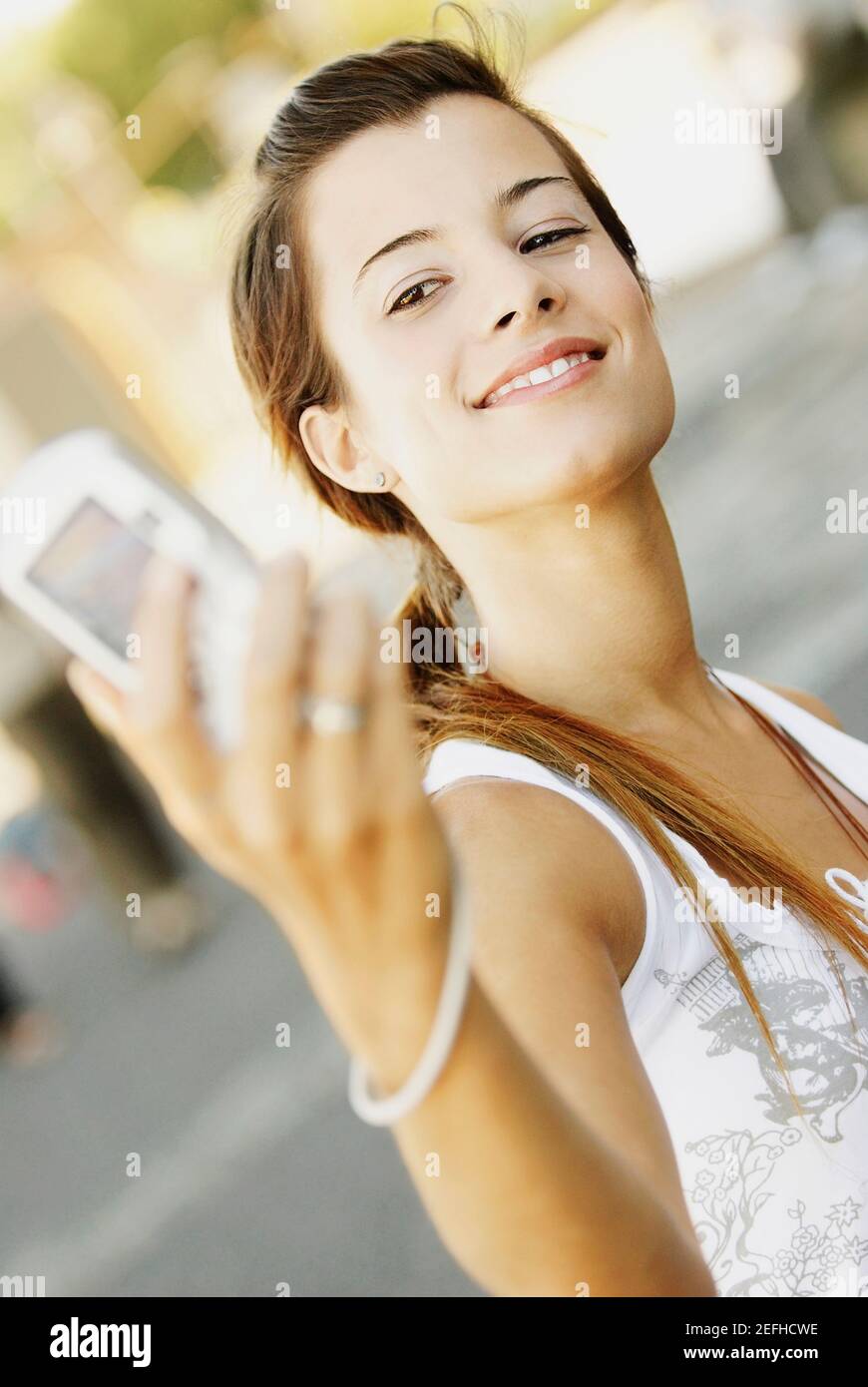 Close up of a young woman taking a photograph of herself Stock Photo
