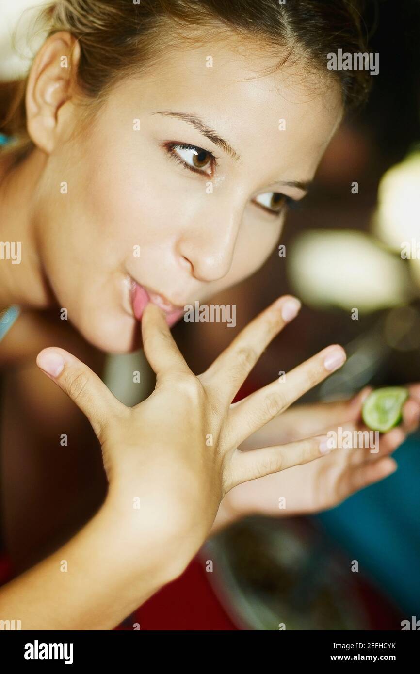 Woman licking her finger hires stock