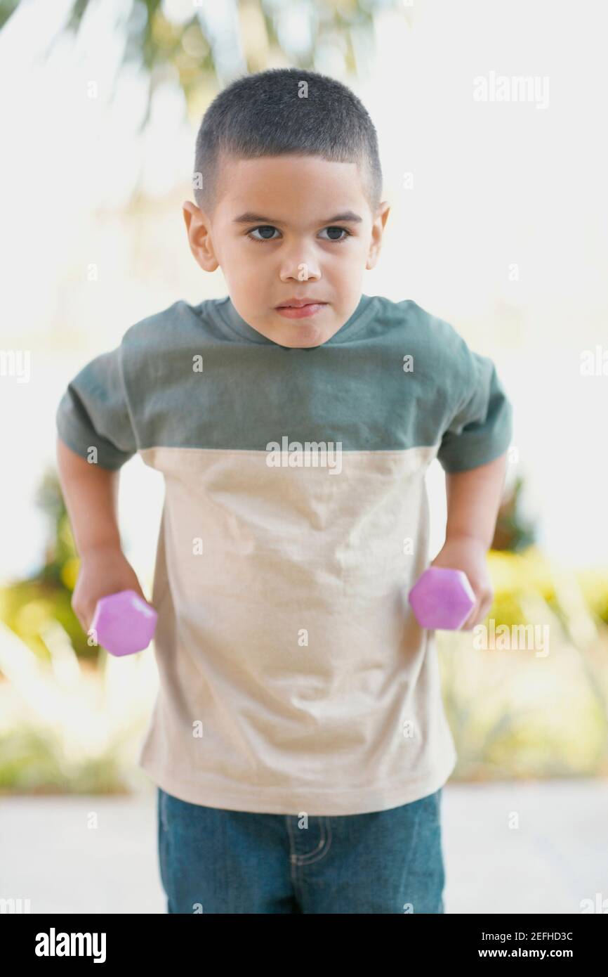 Close up of a boy exercising with dumbbells Stock Photo