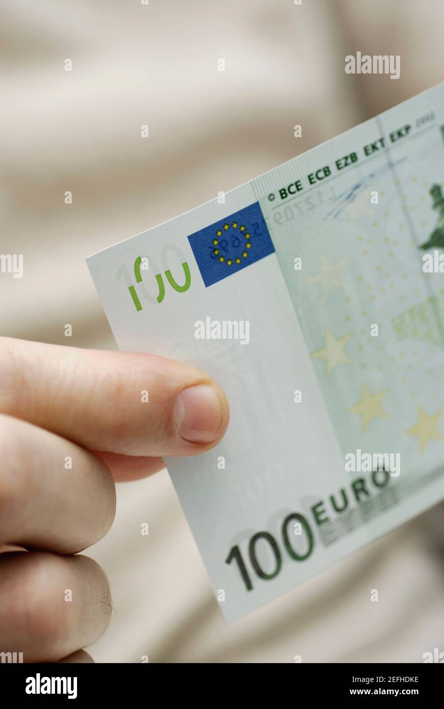 Close up of a personŽs hand holding one hundred Euro banknote Stock ...