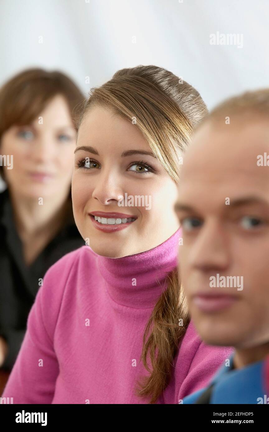 Portrait of a young man with two young women Stock Photo - Alamy