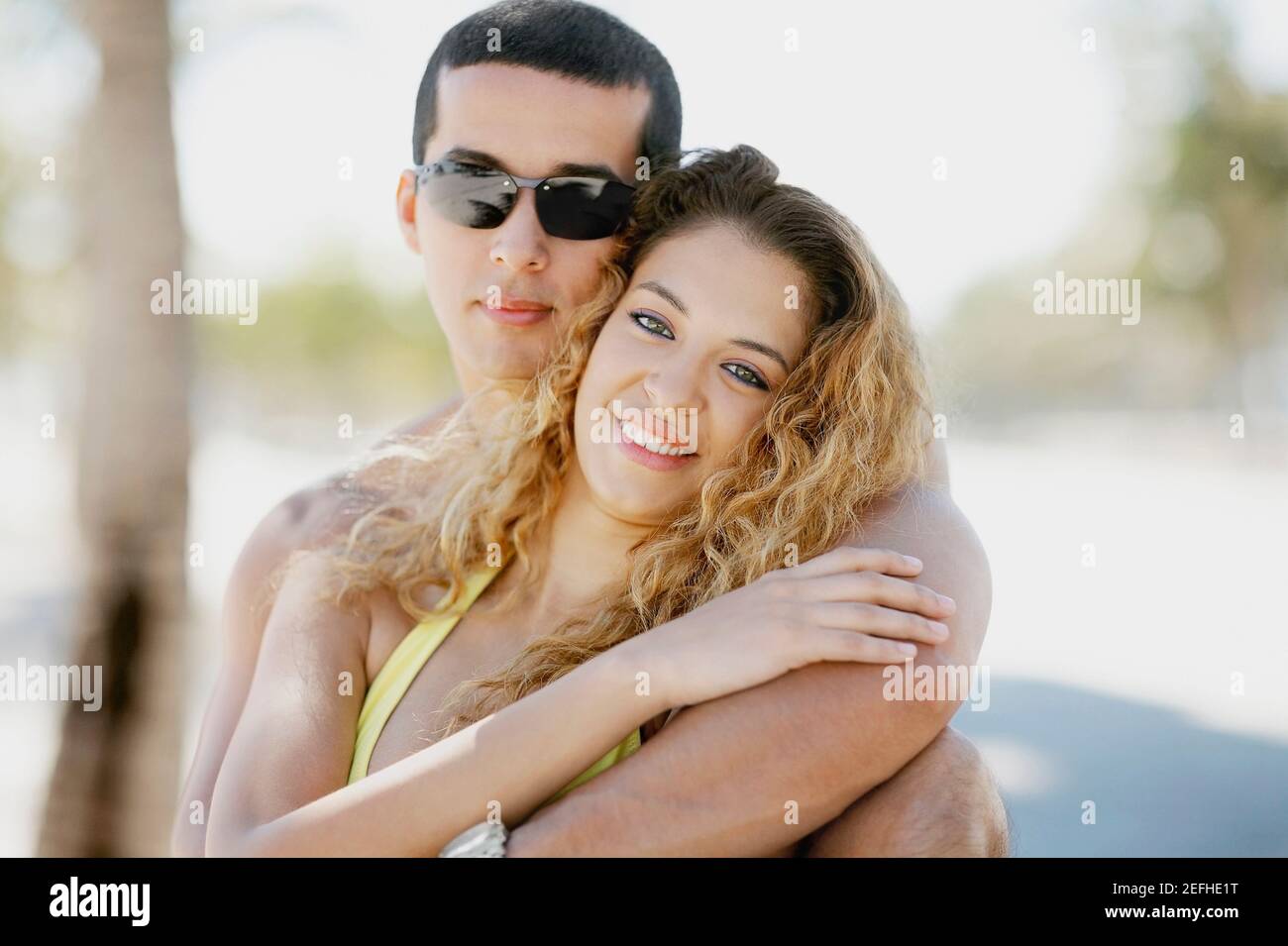 Close up of a mid adult man embracing a young woman from behind Stock ...