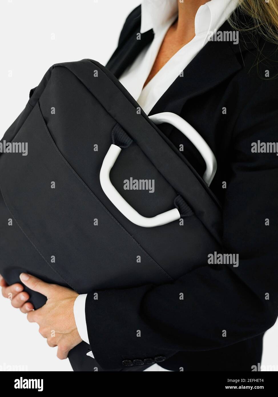 Mid section view of a businesswoman carrying a bag Stock Photo