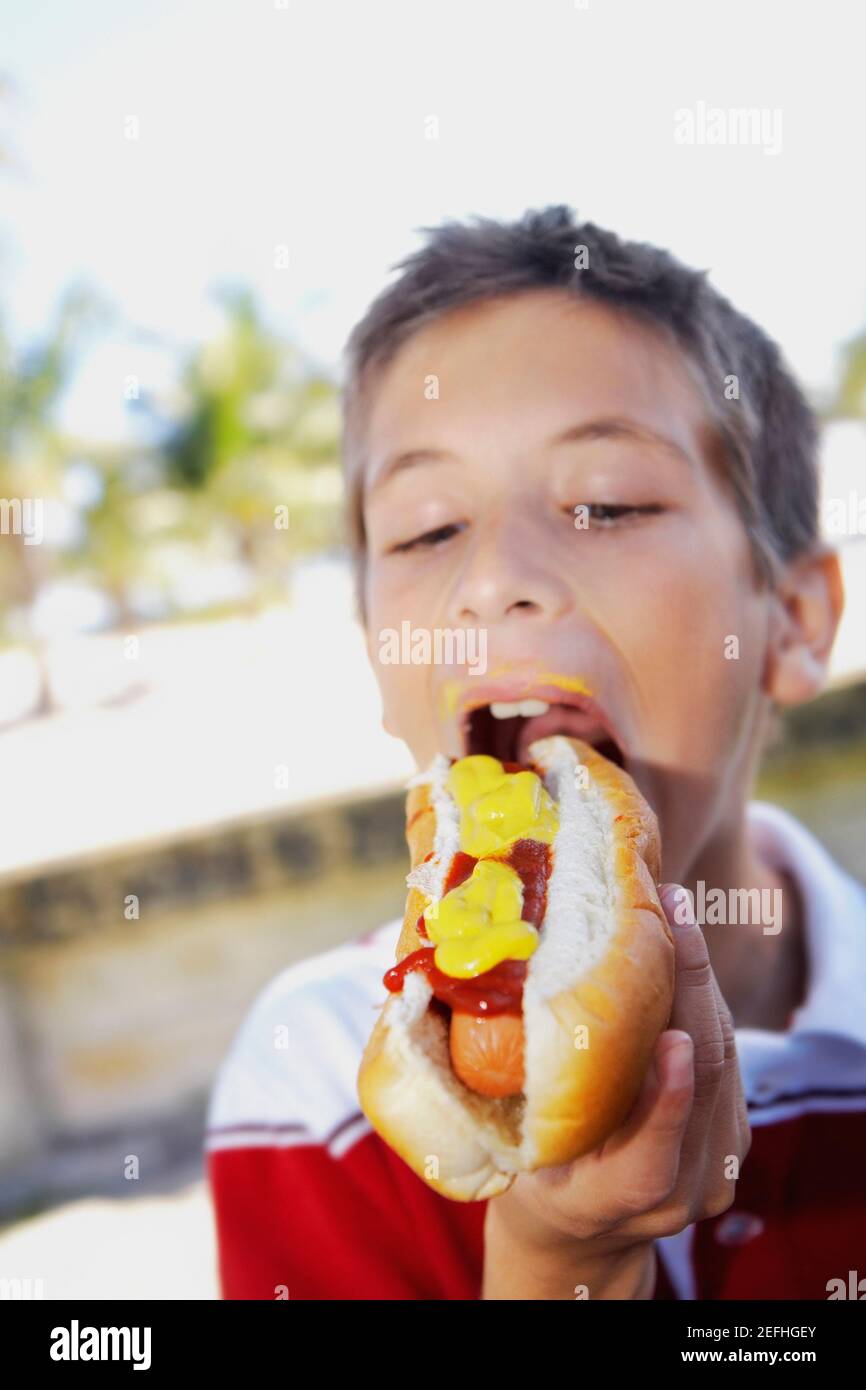 Close up of a boy eating a hot dog Stock Photo