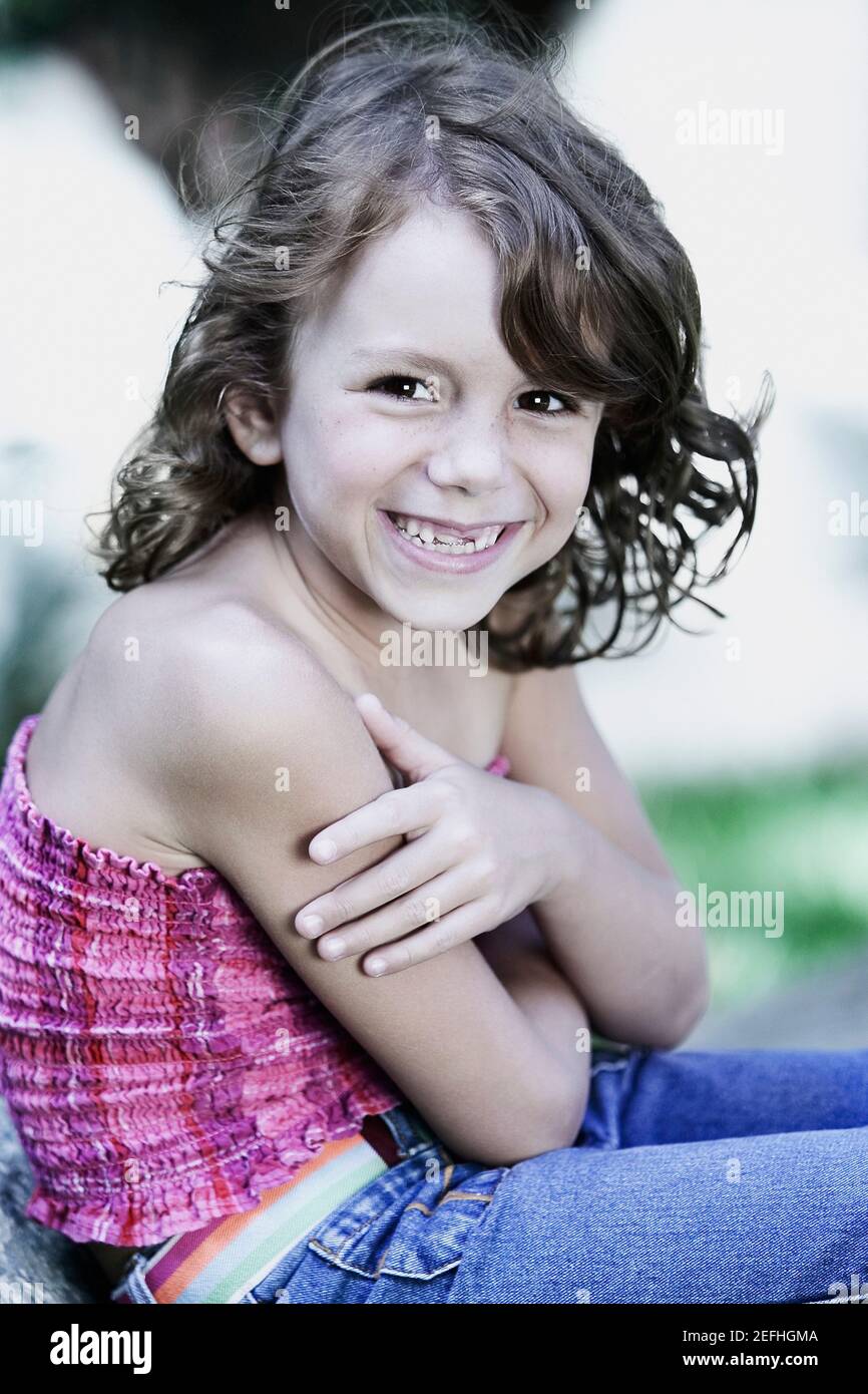 Portrait of a girl with her arms crossed smiling Stock Photo - Alamy