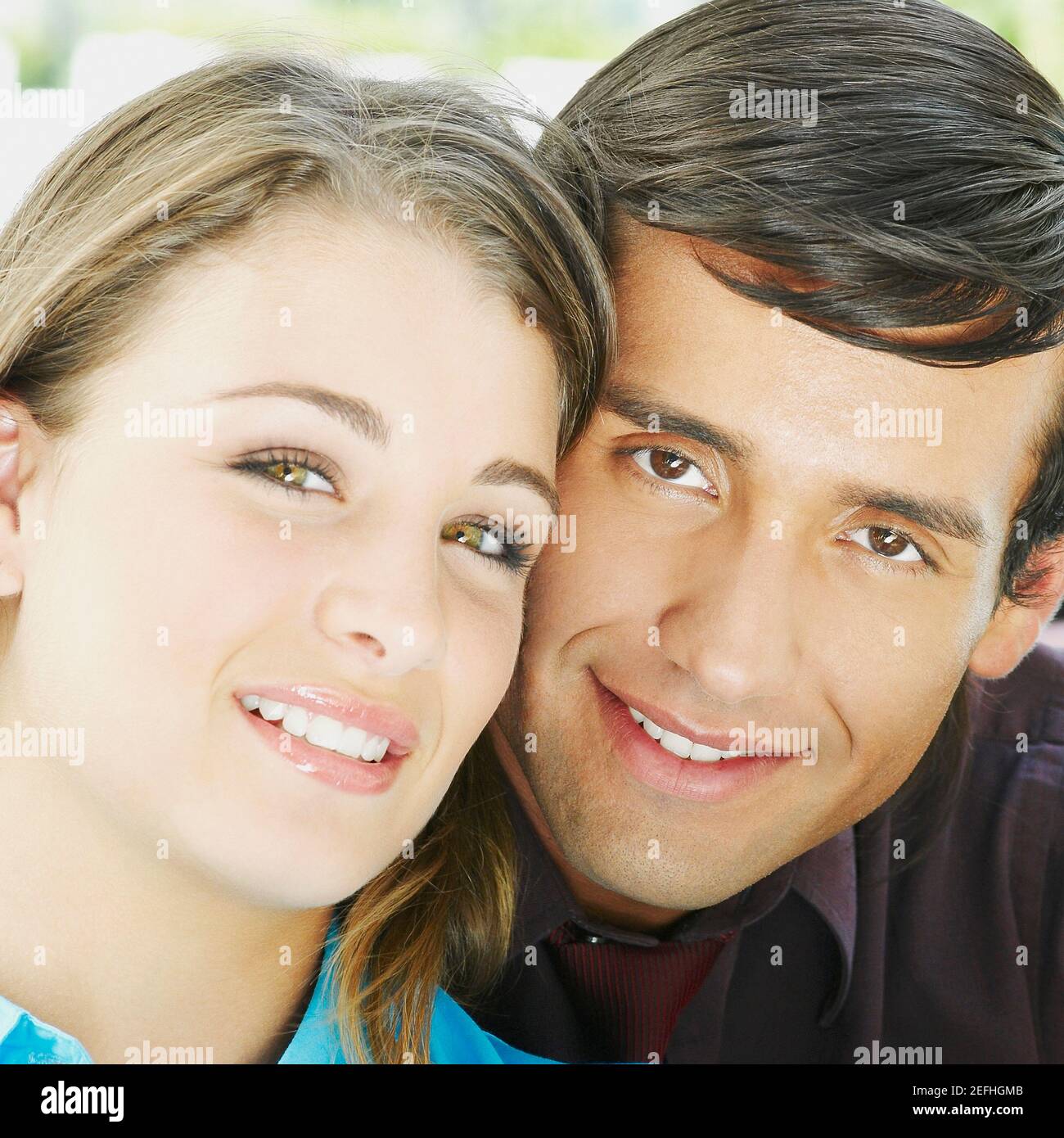 Portrait of a young man and a teenage girl smiling Stock Photo - Alamy