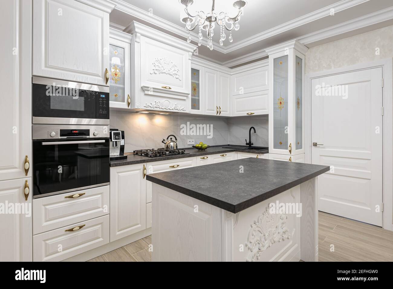 White luxury modern kitchen with island Stock Photo - Alamy