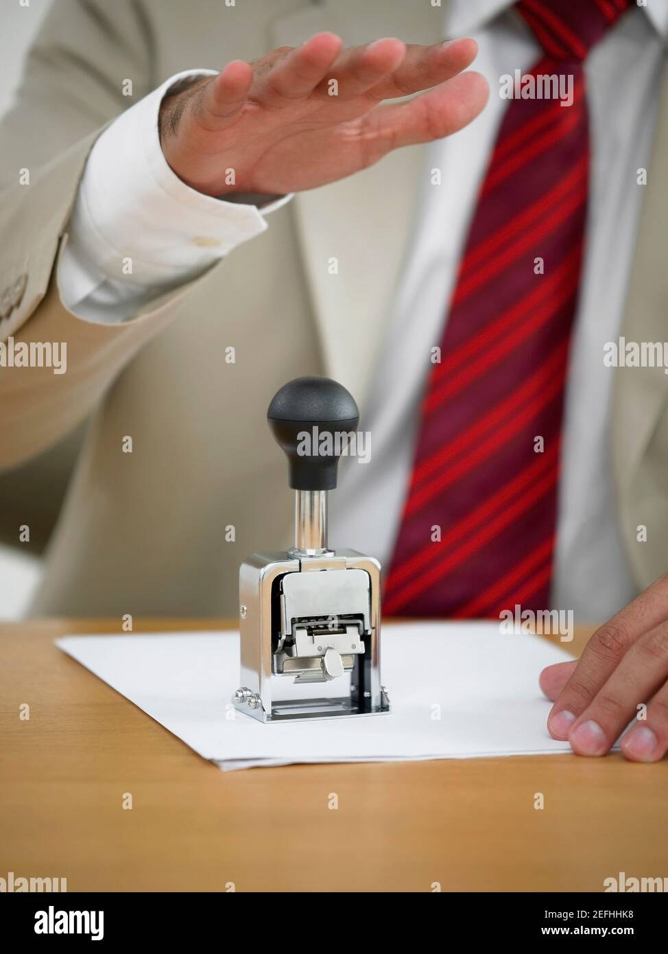 Mid section view of a businessman using a stamp Stock Photo