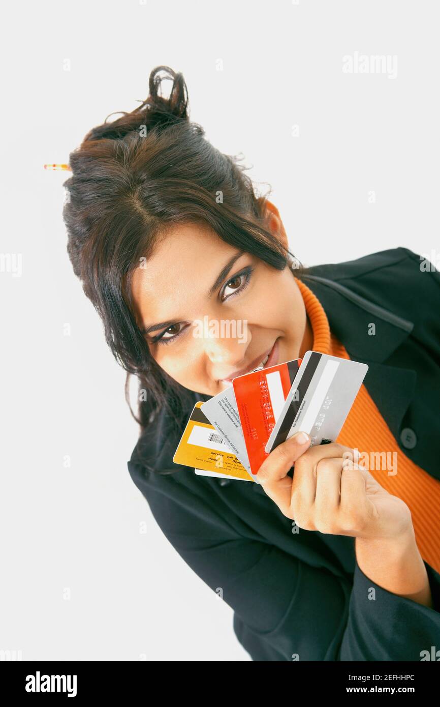 Portrait of a businesswoman holding credit cards and smiling Stock Photo