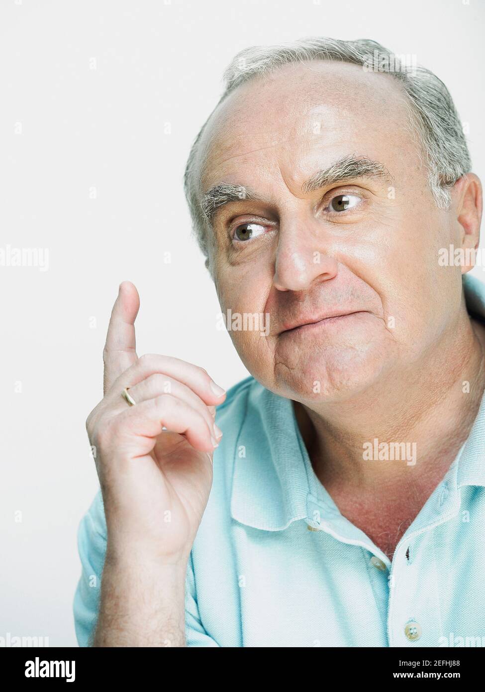Close up of a senior man thinking and gesturing Stock Photo