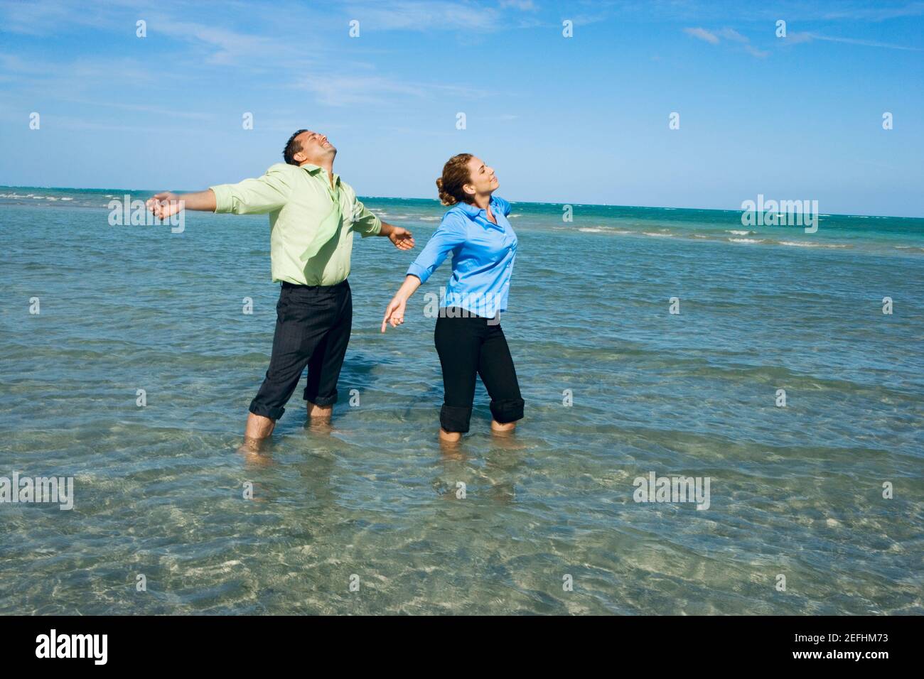 Man with arms outstretched beach hi res stock photography and